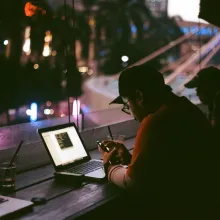 Man on laptop using WiFi, Jakarta Indonesia - Raufan Yusup